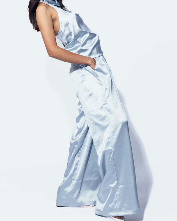 Woman wearing a light blue satin dress on a white background